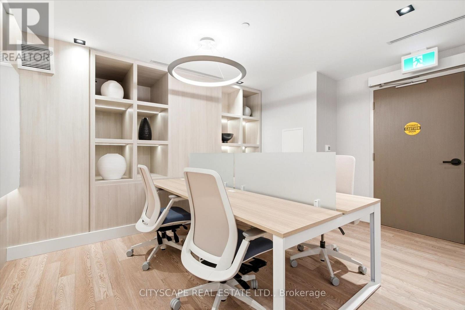 A conference room with a table, chairs and shelves.