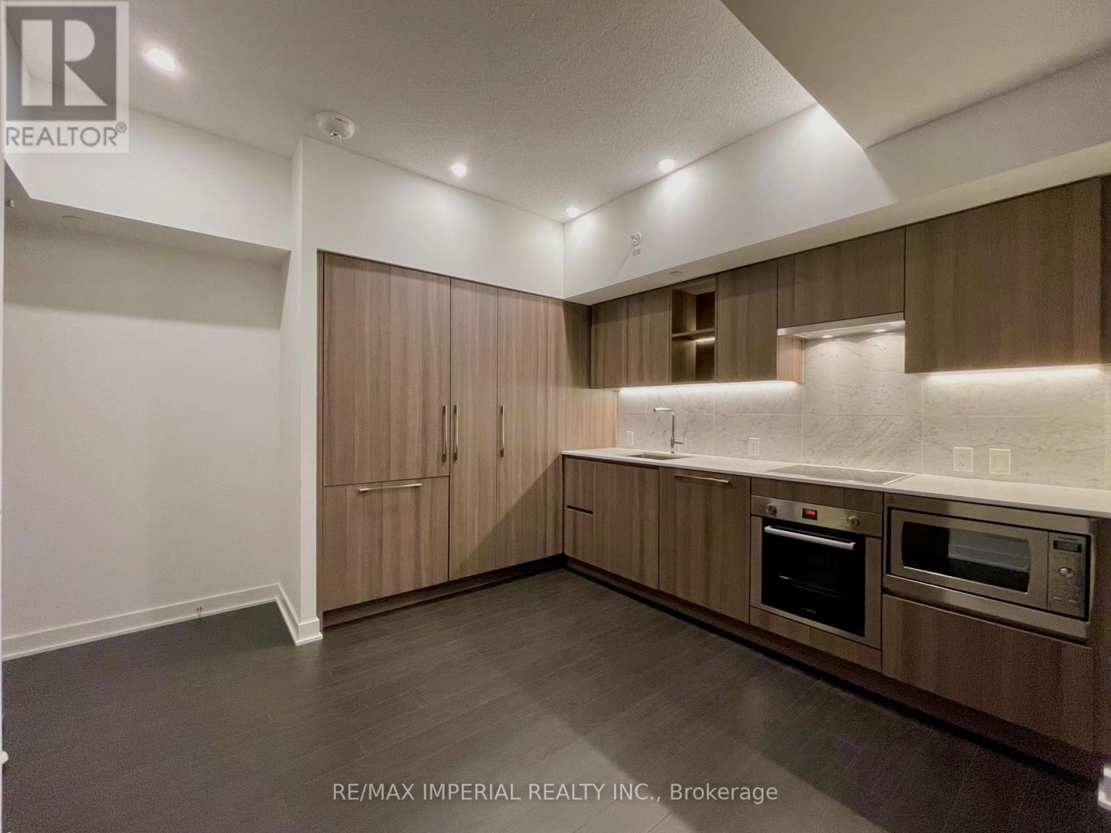 A kitchen with wooden cabinets and stainless steel appliances.