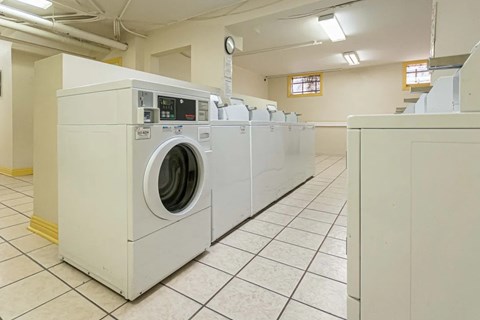 A row of washing machines in a laundromat.