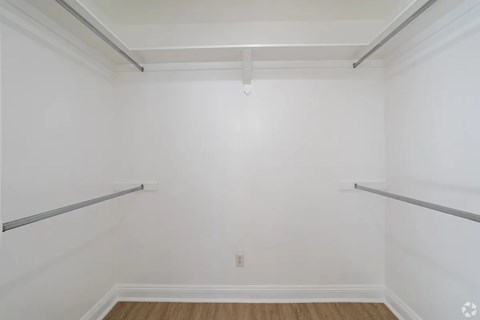 A white room with a wooden floor and a white ceiling.