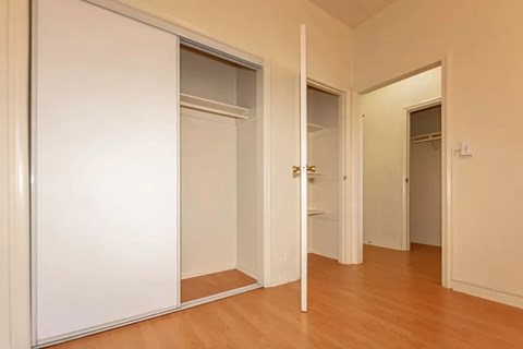 A white door with a mirror on the left side.