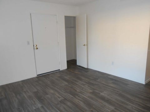 A room with a white door and a grey door.