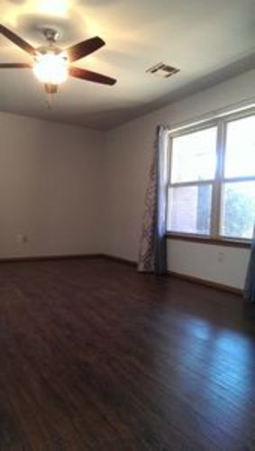 A room with a ceiling fan and a window.