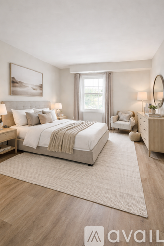 A bedroom with a large bed and a wooden floor.