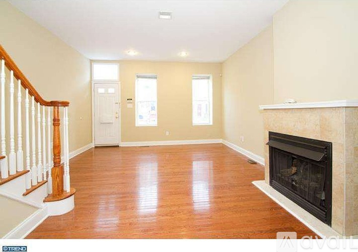 A living room with a fireplace and hardwood floors.