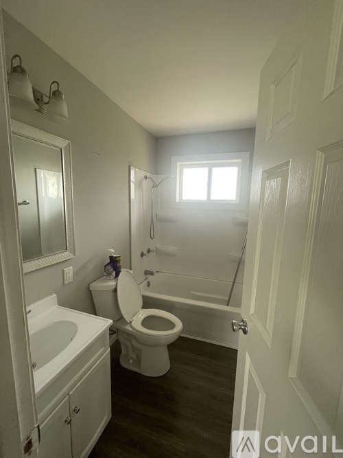 A bathroom with a toilet, sink, and bathtub.