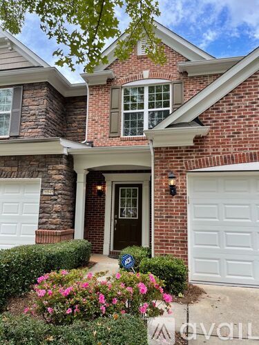 A house with a brick facade and a white garage door.