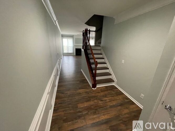 A long hallway with a staircase on the right side.
