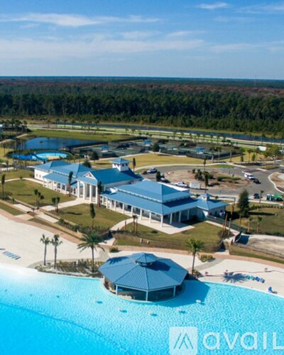 A large building with a pool in front of it.