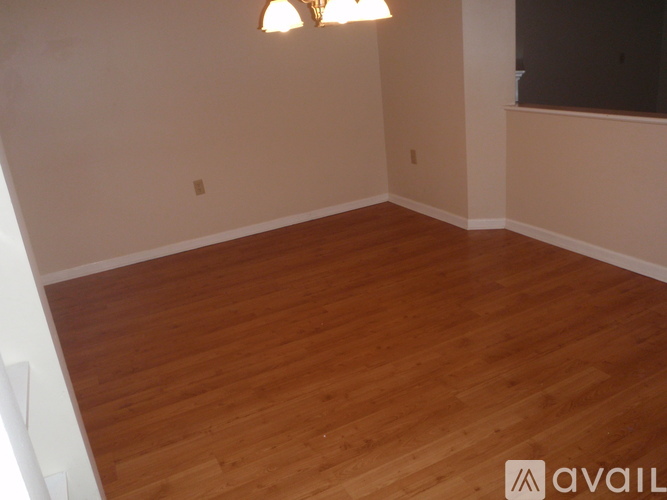 A room with wooden flooring and a light fixture.