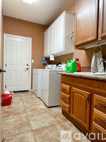 A kitchen with brown walls and white appliances.