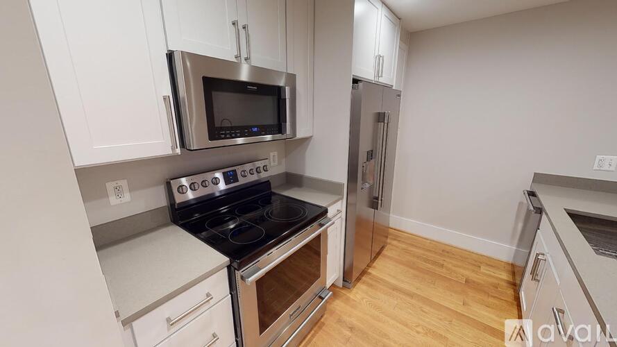 A kitchen with a stove top oven and a microwave above it.