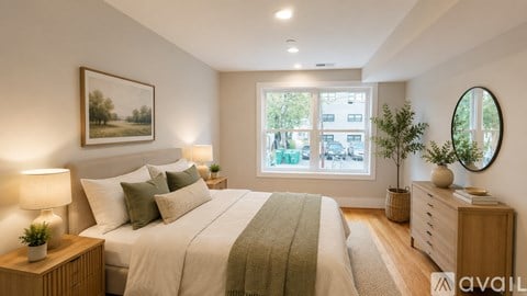 A room with wooden floors and two windows.