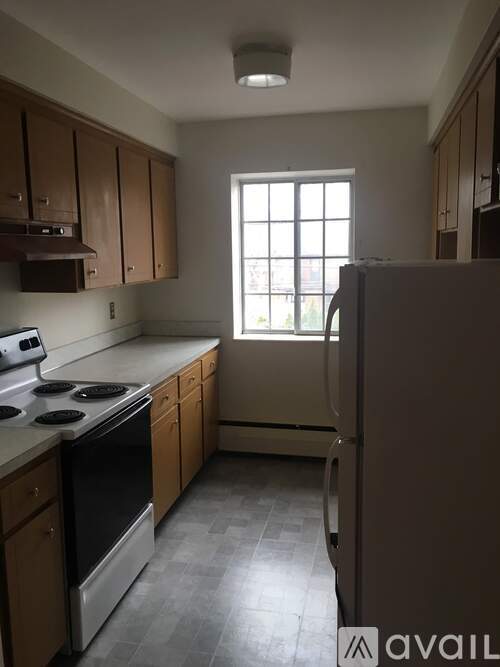 A kitchen with wooden cabinets and a stove top oven.