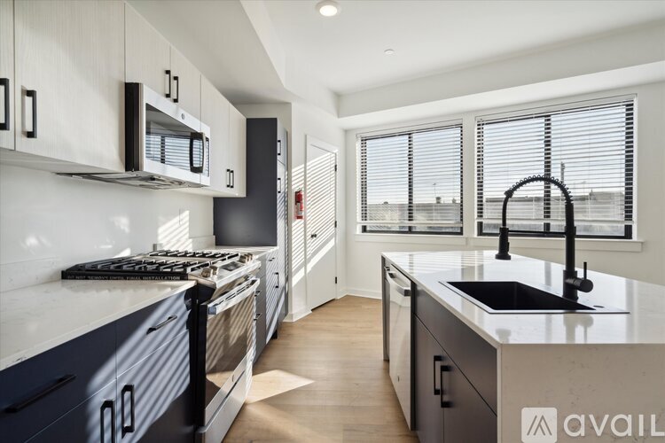 A modern kitchen with a black and white color scheme.