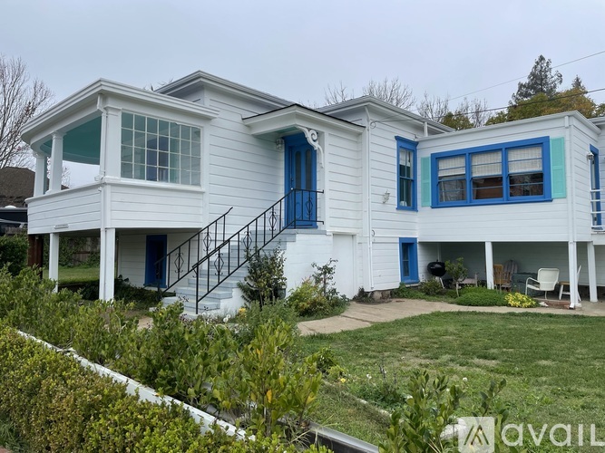 A white house with blue trim and doors.