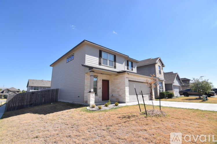 A house with a brown front yard and a clear blue sky.
