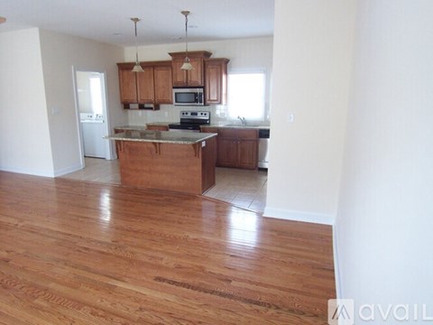 A kitchen with wooden cabinets and a center island.