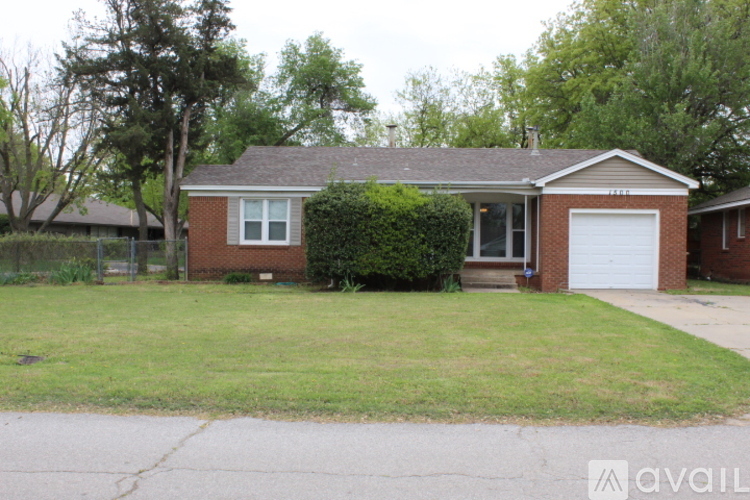 A house with a white garage door and a brick exterior.
