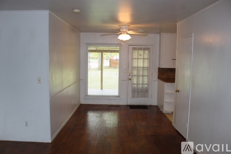 A room with a wooden floor and a ceiling fan.