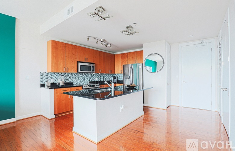 A kitchen with wooden cabinets and a black countertop.