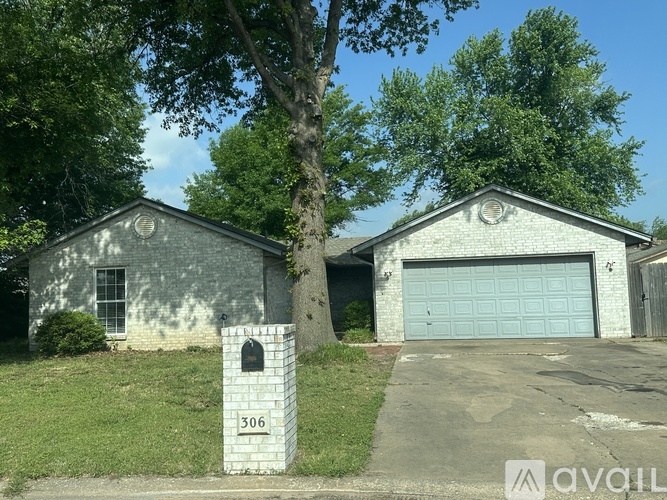 A house with a blue garage door is for sale.