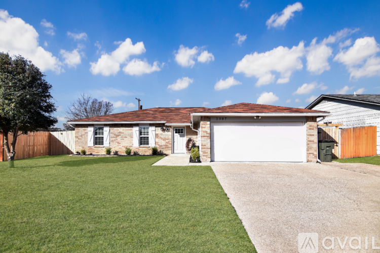 A house with a white garage door is for sale.