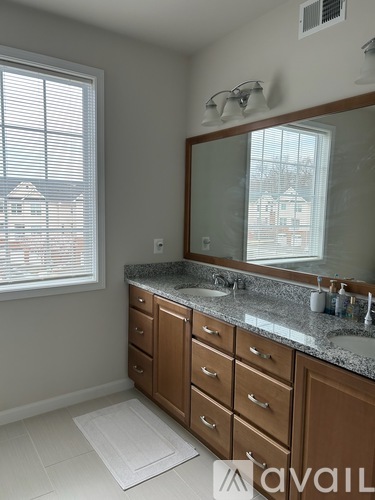 A bathroom with a large mirror and a sink.