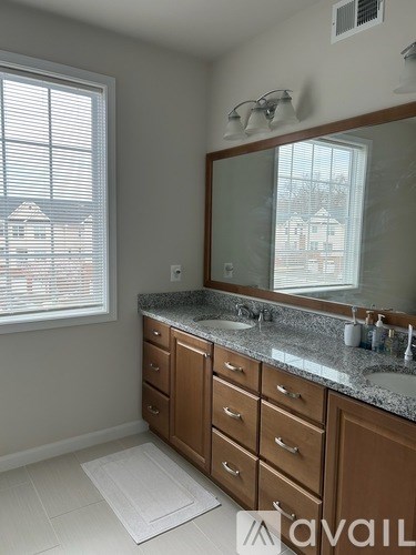 A bathroom with a large mirror and a sink.