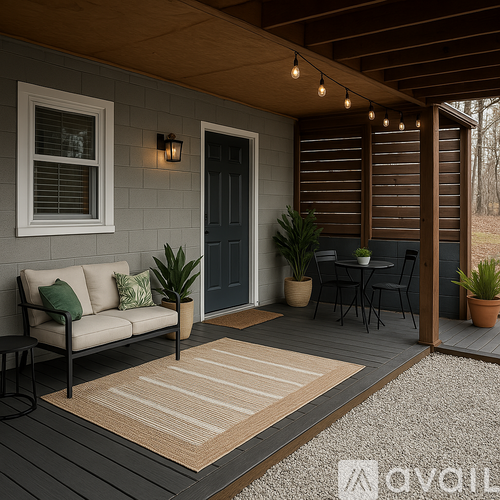 A cozy outdoor patio with a couch, table, and chairs.