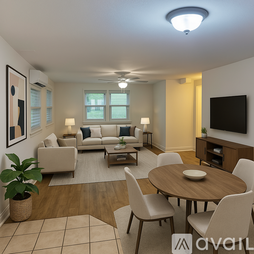 A living room with a couch, chairs, and a television.