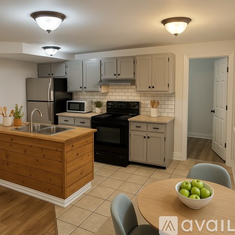 A kitchen with a wooden island and black appliances.