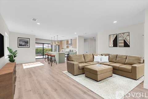 A modern living room with a large sectional sofa and a coffee table.