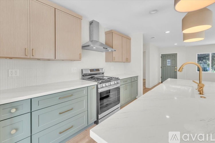 A kitchen with a white countertop and blue cabinets.