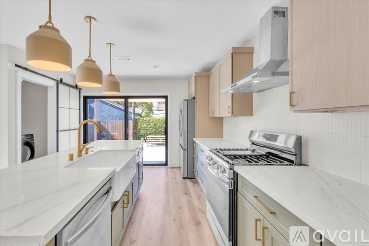 A kitchen with a white counter top and wooden cabinets.
