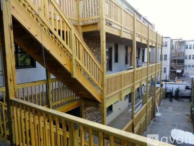 A wooden staircase is in the middle of a building under construction.