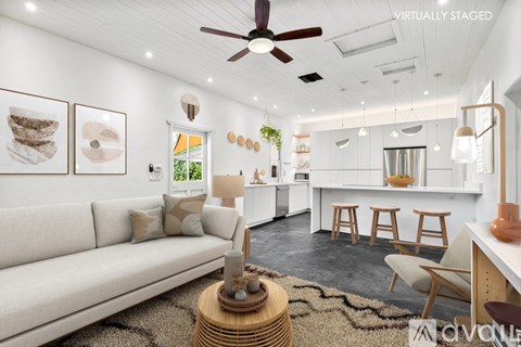 A living room with a white couch and a wooden coffee table.