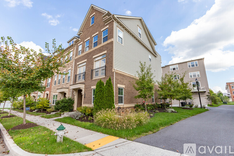 A large brick apartment building with a green fire hydrant in front of it.