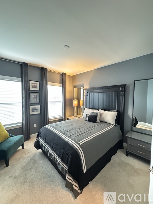 A bedroom with a large bed and a green bench.