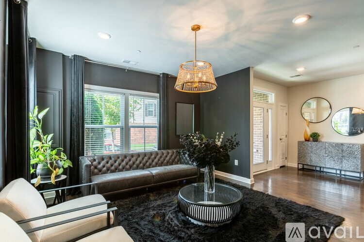 A modern living room with a brown leather sofa and a glass coffee table.