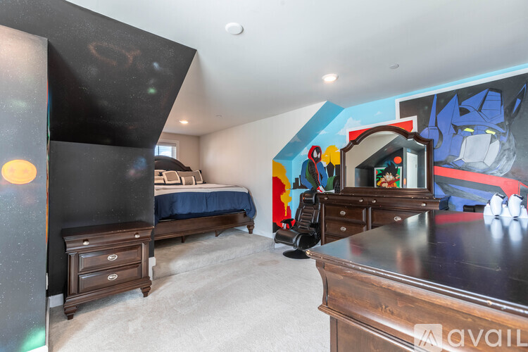A bedroom with a bed, dresser, and mirror.