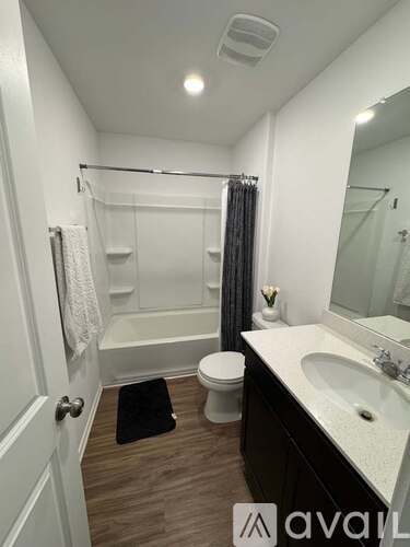 A bathroom with a toilet, sink, and bathtub.