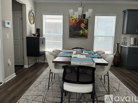 A dining room with a table set for six people.