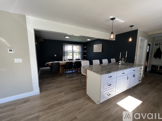 A kitchen with a table and chairs in the middle of the room.