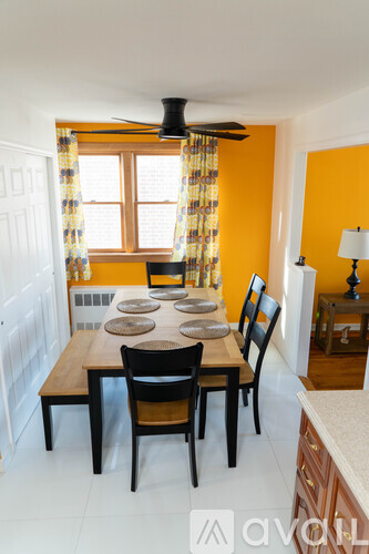 A dining room with a table set for six.