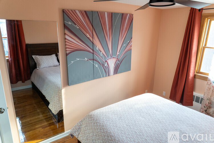 A bedroom with a large bed and a ceiling fan.