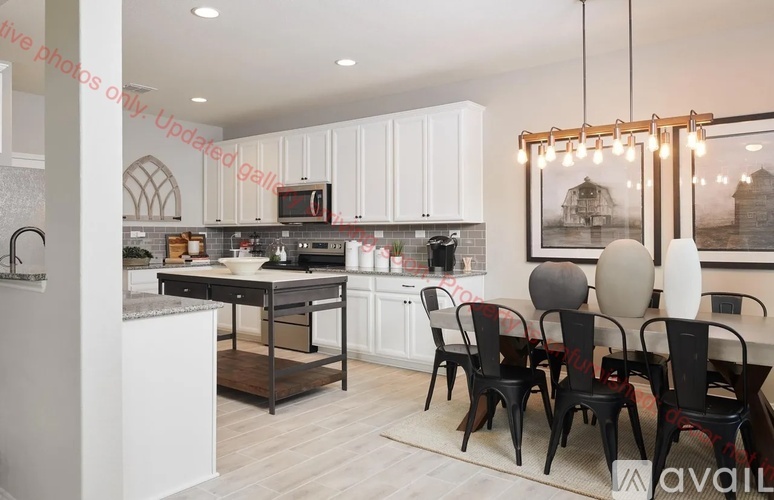 A modern kitchen with a dining table set for four.