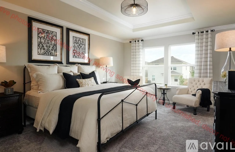 A bedroom with a large bed and a chair.