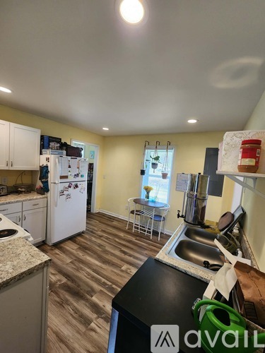 A kitchen with a sink and a refrigerator.