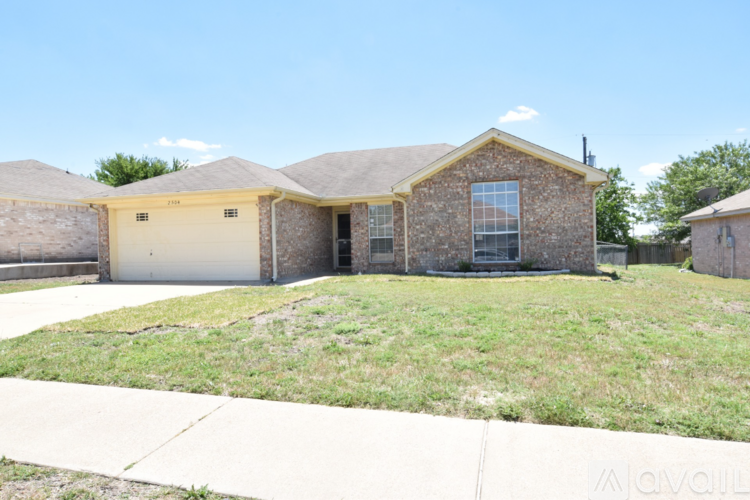 A house with a garage and a driveway in front.
